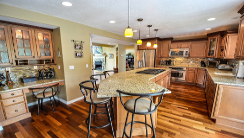 Very spacious kitchen with beige granite countertop